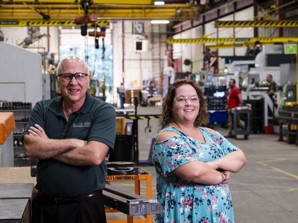 Two people standing in a manufacturing facility