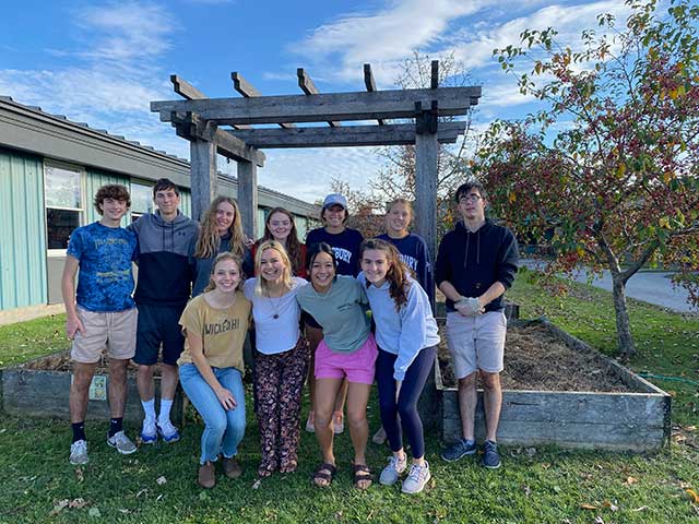 The student organization Nutrition Outreach & Mentoring (NOM) works in the community garden at Mary Hogan Elementary, providing access to fresh and healthy food.
