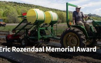 Farmer Eric Rozendaal riding a tractor in a field in the spring